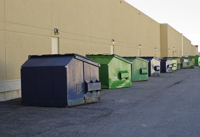 a series of colorful, utilitarian dumpsters deployed in a construction site in Hinesville